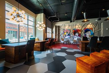A room with a black and white checkered floor and a mural on the wall.